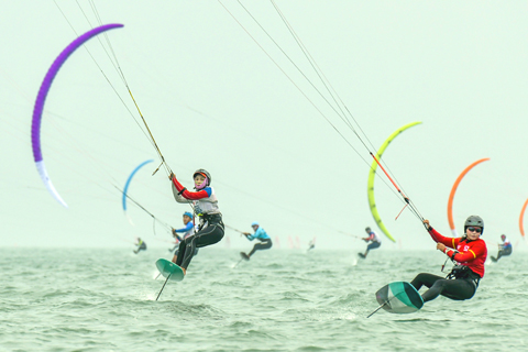 ◎ 十二月十七日,二0二一年全國帆船錦標賽及全國風箏板錦標賽正在海口附近海域進行。比賽共有來自海南、浙江、廣東、福建、上海、四川等十八個代表隊近二百名運動員參賽。圖為參加全國風箏板錦標賽的選手正在比賽中。(中新社記者 駱雲飛 攝)