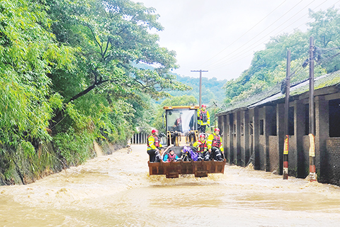 ◎ 六月十三日,福建省龍岩市氣象局發佈暴雨橙色預警,防暴雨應急響應提升為Ⅲ級。當日,福建省龍岩市新羅區河水暴漲,街道積水嚴重。當地積極響應,迅速投入一線搶險救援。圖為受災民眾坐鏟車轉移。(中新社發 新羅區融媒體中心 供圖)