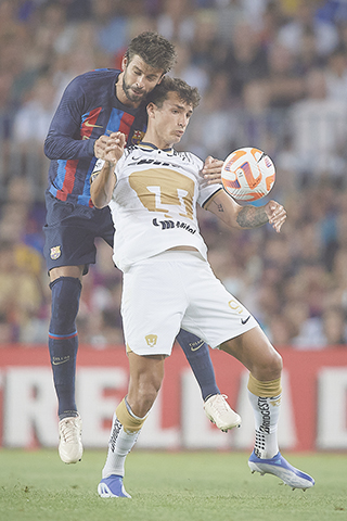 ◎ 八月七日,巴塞隆拿隊球員比基(後)與美洲獅隊球員迪奴在比賽中拼搶。在二零二二年甘伯杯足球賽中,西甲巴塞隆拿隊以六比零戰勝墨超美洲獅(普馬斯)隊,獲得冠軍。(新華社發)