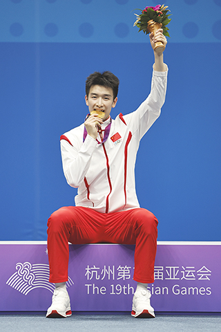 ◎ 十月七日,冠軍中國選手李詩灃在領獎台上。在杭州亞運會羽毛球男子單打決賽中,中國選手李詩灃以二比0戰勝中國選手石宇奇,獲得冠軍。(新華社記者任正來 攝)