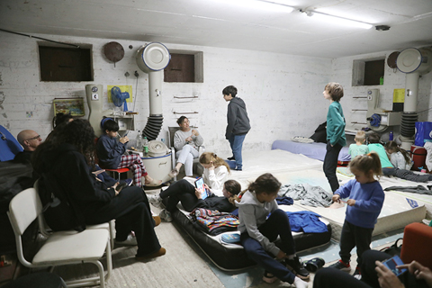 ◎ 二月二十八日,以色列民防軟件顯示,以色列全境多座城市再次響起防空警報。新華社記者在特拉維夫聽到城市上空傳來爆炸聲,並看到天空中有以軍防空系統發射攔截彈留下的白色煙軌。圖為當日,防空警報響起後,以色列特拉維夫的民眾進入避難設施。(新華社發吉德翁.馬科維奇攝/基尼圖片社)